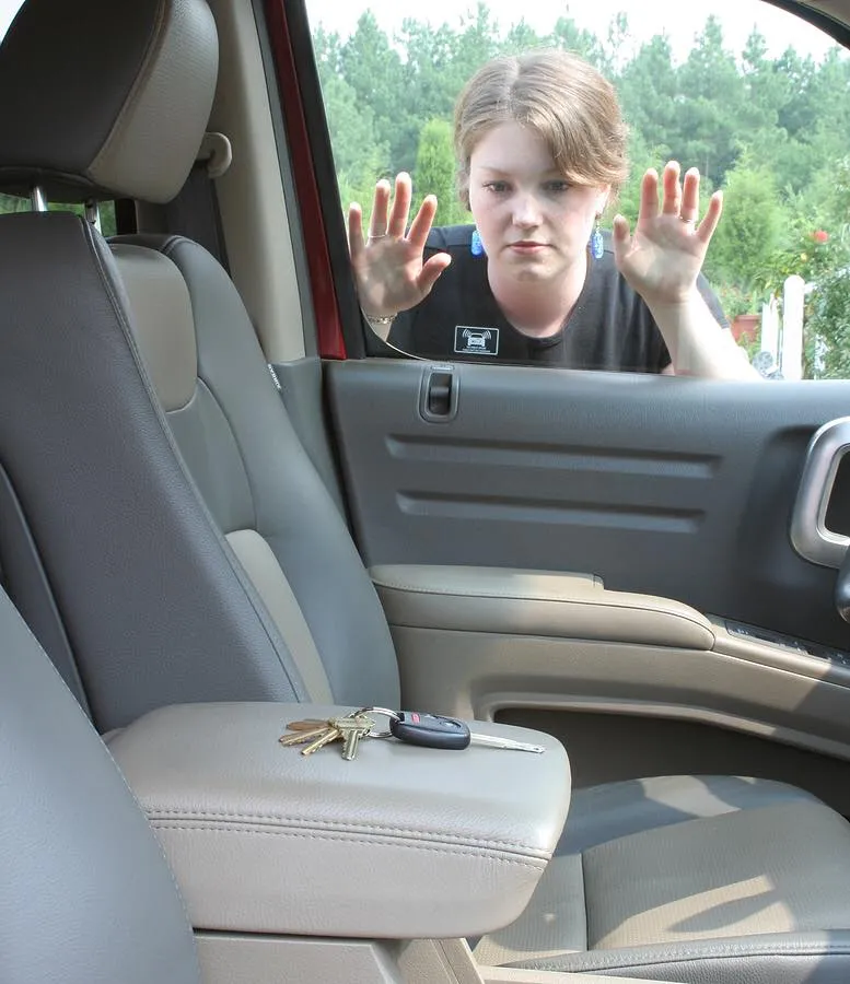 A woman in the driver 's seat of a car.